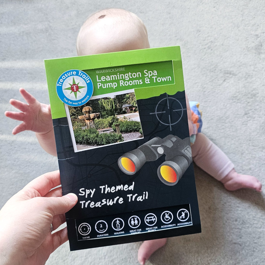 Baby reaching for Treasure Trails pack